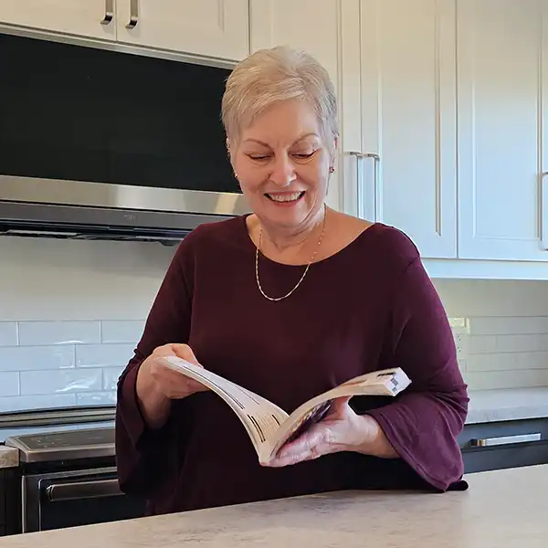 Oma Gerhild holding cookbook